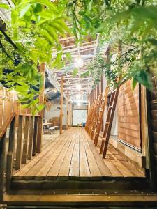a wooden corridor in a building with trees at Bisita Hostel in Siquijor