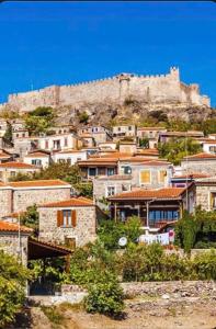 a city with a castle on top of a hill at Ayvalik Bir Tebessum in Ayvalık