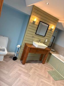 a bathroom with a sink and a toilet at The willow tree inn in Pilsley +38 photos