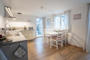 a kitchen and dining room with a table and chairs at Chalet zum See in Bregenz