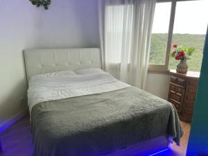 a bedroom with a large bed with a window at habitacion a 15 min playa d aro in Romanyá de la Selva +10 photos