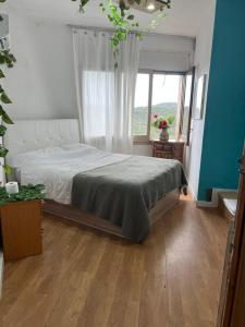 a bedroom with a bed and a window at habitacion a 15 min playa d aro in Romanyá de la Selva