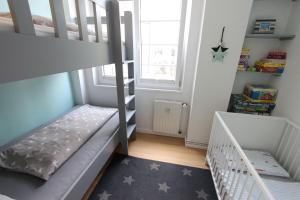 a small room with a bunk bed and a staircase at Langeoog entspannt in Langeoog