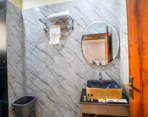 a bathroom with a sink and a mirror at Aarchh Royale in Noida +38 photos