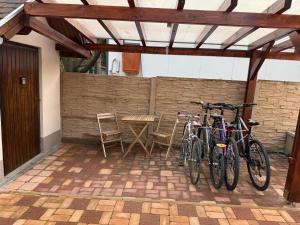 two bikes parked under awning on a patio at Rsd-Tass vendéghàz in Tass