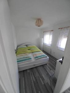 a small bedroom with a bed in a room at Rsd-Tass vendéghàz in Tass +5 photos