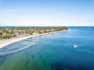 an aerial view of a beach with a boat in the water at Atlantic Dependance Travemünde in Travemünde