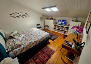 a bedroom with a bed and a table in a room at Mansarda Acquamarina in Viareggio