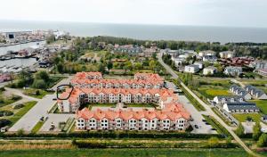 an aerial view of a large building with orange roofs at Apartament Charlie in Darlowko