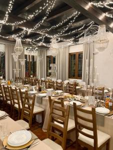 a dining room with tables and chairs and chandeliers at HOTEL LEMONIADA in Lućmierz