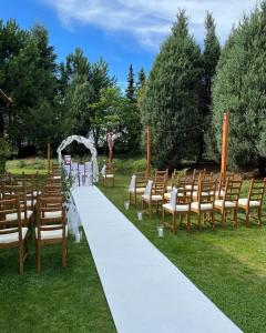a wedding aisle with chairs and a white aisle at HOTEL LEMONIADA in Lućmierz