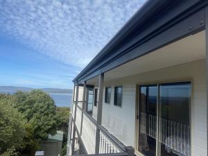 a balcony of a house with a view of the water at Pillais B and B in Albany