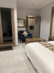a bedroom with a bed and a blue couch at شقة تراحيب الشمال للضيافة in Riyadh +7 photos