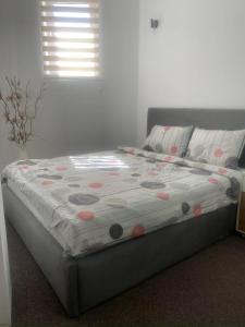 a bed with a quilt on it in a bedroom at Petar Apartment in Mavrovo