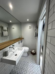 a bathroom with a sink and a toilet at Studio 77 Cheltenham in Cheltenham