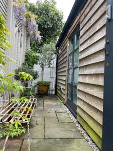 a patio with a bench next to a house at Studio 77 Cheltenham in Cheltenham