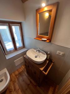 a bathroom with a sink and a mirror at L'Antico Piol de Feltre in Feltre +16 photos
