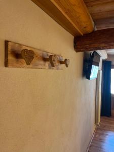 a wall with two wooden hearts on it at L'Antico Piol de Feltre in Feltre
