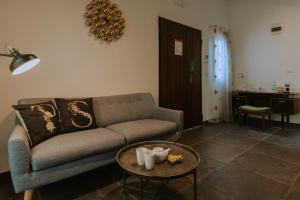 a living room with a couch and a table at Pjazza Suites Boutique Hotel by CX Collection in Siġġiewi