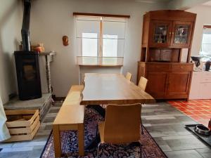 a kitchen with a wooden table and a stove at Casa Laetitia in Acquarossa