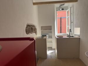a small kitchen with a sink and a window at azul rooms & suites in Olbia