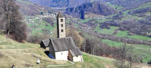 an old house on a hill with a church at Casa Laetitia in Acquarossa
