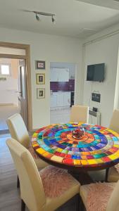 a dining room with a table with a colorful centerpiece at House Nena in Bibinje