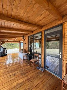 an open living room with wooden flooring and sliding glass doors at KraftColibita in Colibiţa
