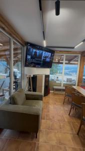a living room with a couch and a flat screen tv at KraftColibita in Colibiţa