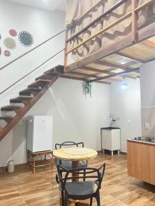 a room with a table and chairs and a staircase at Apt estiloso 01 in Paragominas