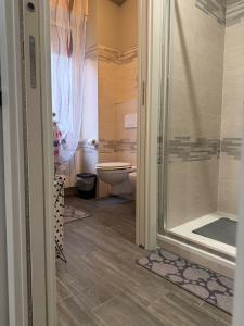 a bathroom with a toilet and a glass shower at Casa di Ema in Sanremo +17 photos