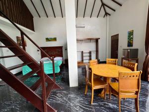 a room with a table and chairs and a bed at JungleRiverHouse & JungleRiverResort in Bukit Lawang +99 photos