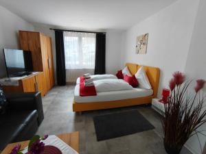 a living room with a bed and a couch at Piroska Pension in Olbernhau