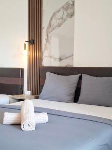 a bedroom with a bed with towels on it at Apartments Perezaj II in Ulcinj