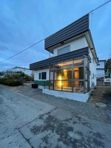 a house with a large window on the side of it at 呼人2 Arun別邸 in Abashiri
