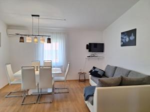 a living room with a couch and a table at Apartmani Drago in Vir