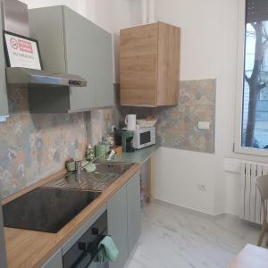 a kitchen with a sink and a microwave at Civico8 in Pavia