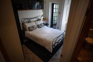 a bedroom with a bed with a black frame at Sea View Ultimate Boutique escape! in Barnstaple