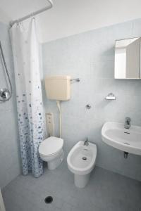a bathroom with a toilet and a sink at Dipendenza Hotel Regal in Rimini +10 photos