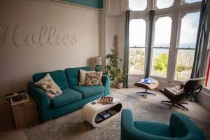 a living room with a blue couch and chairs at Sea View Ultimate Boutique escape! in Barnstaple