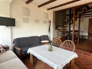 a living room with a table and a couch at Domček Ami in Stará Lesná