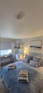 a bedroom with a large bed with towels on it at Wayside Cottage Gairloch Room Accommodation in Gairloch