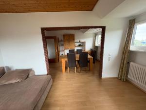 a dining room with a table and chairs and a room with at Ferienwohnung Stephinsky in Bad Münstereifel +15 photos