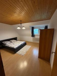 a bedroom with a bed and a wooden ceiling at Ferienwohnung Stephinsky in Bad Münstereifel