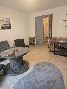 a living room with a couch and a table at Ferienwohnung 1 am Bahnhof in Bernburg +18 photos
