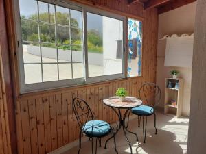 a room with a table and chairs and a window at Villa Konstantinos with Private Pool in Paphos