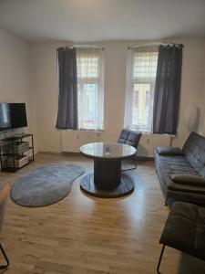 a living room with a couch and a table at Ferienwohnung 1 am Bahnhof in Bernburg