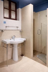 a bathroom with a sink and a shower at Skylark Resort in Colva +32 photos
