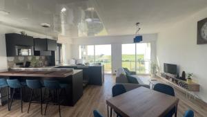 a kitchen and living room with a table and chairs at Appartement face golf et océan in Saint-Jean-de-Monts