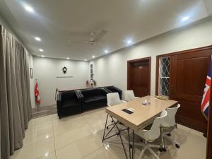 a living room with a table and a couch at Bridge Residency in Islamabad